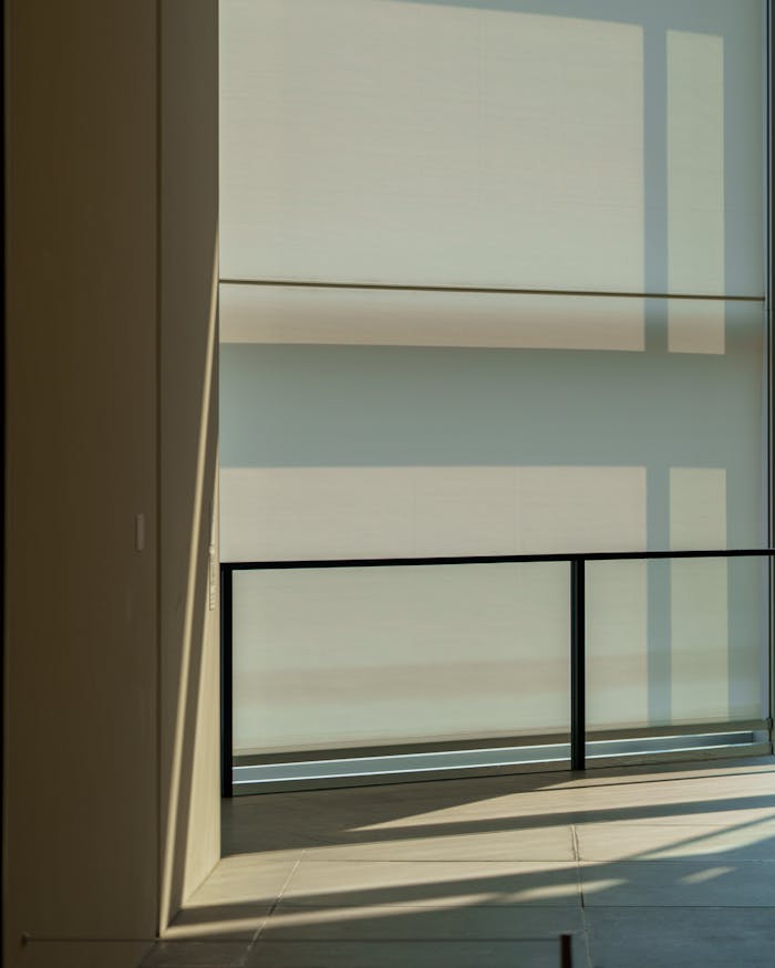 Modern interior with sunlight casting geometric shadows on walls.